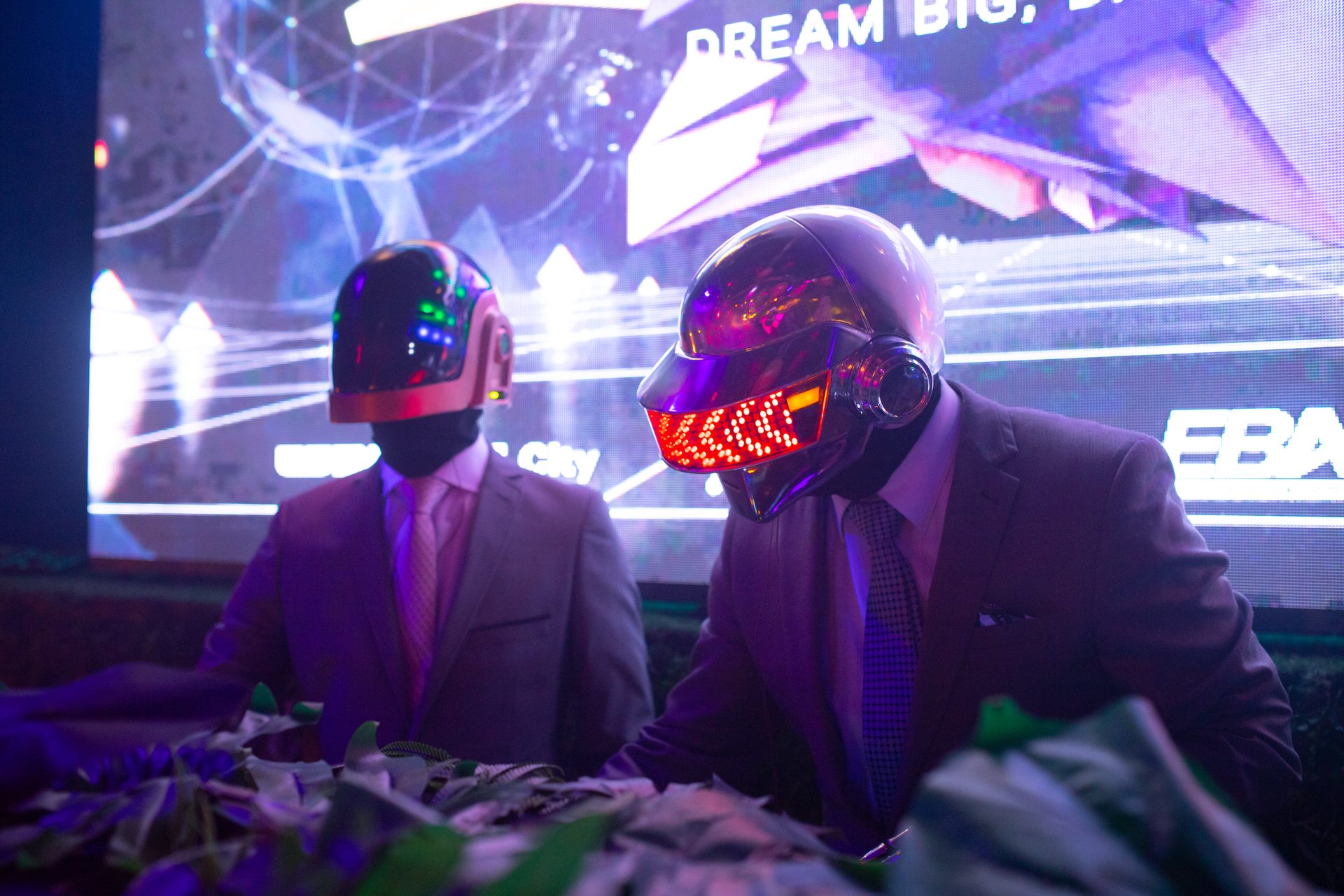 LED performers at BTQ event with purple stage lighting