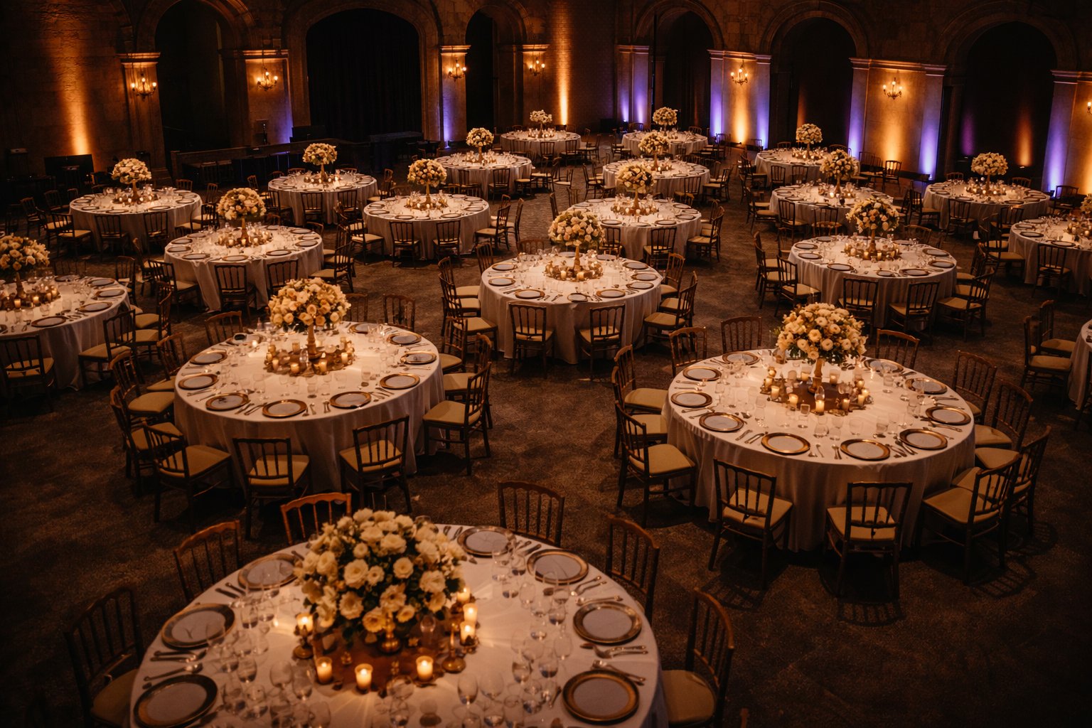 Guests dancing among floral arrangements at a gala dinner