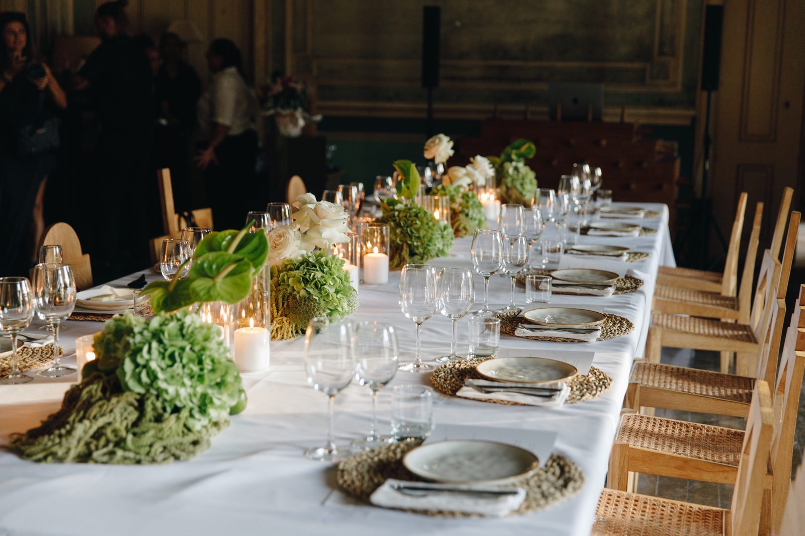 Candlelit table setting at L'Oréal gala dinner with botanical centrepieces