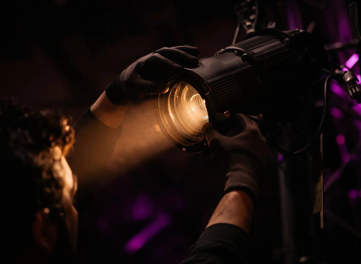 Lighting technician preparing stage for private event