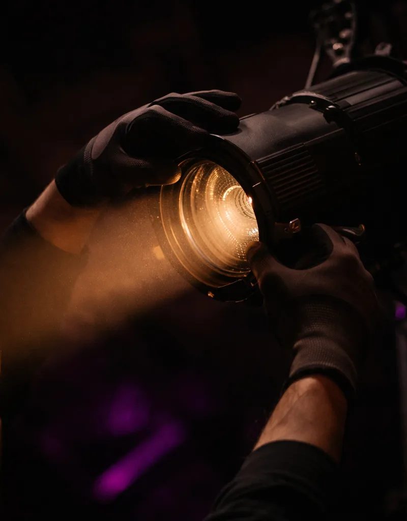 Lighting technician preparing stage for conference