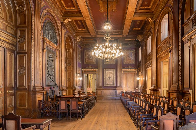 Sala Assembleias Gerais at Palácio da Bolsa, showing the assembly chamber configured by BTQ Events as a registration and breakout space for a corporate conference programme
