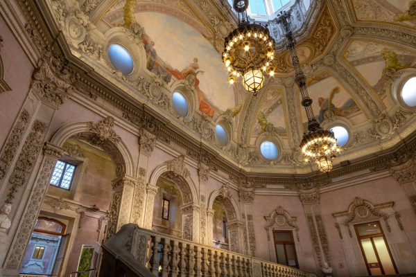 Escadaria Nobre at Palácio da Bolsa, Porto — gilded twin-flight staircase under glass-domed light