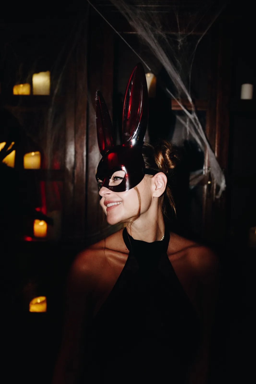Masked guest in candlelight at a BTQ-produced surprise milestone celebration in Portugal