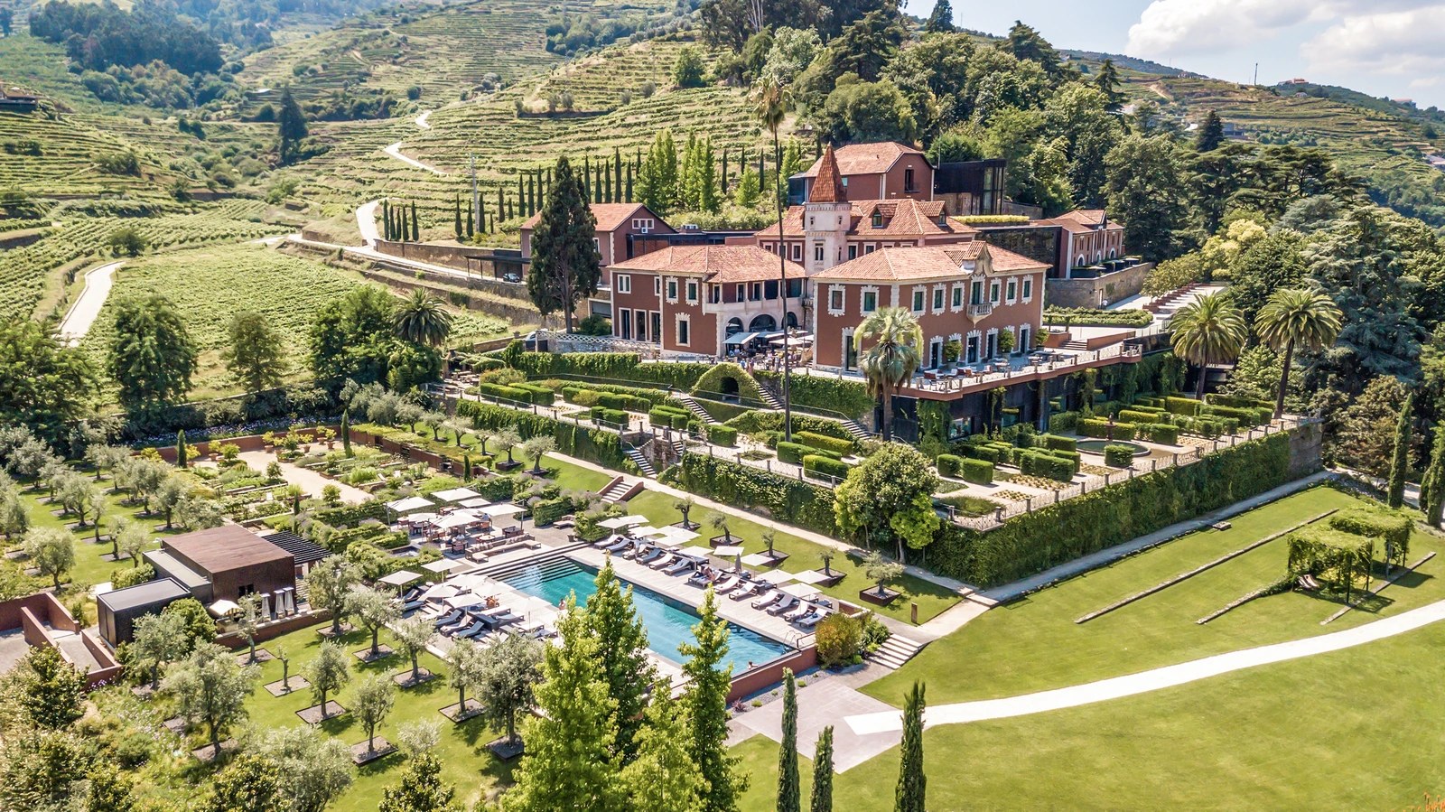 Six Senses Douro Valley · restored 19th-century quinta and terraced vineyard panorama above the Douro river, used by BTQ Events for multi-day corporate retreats
