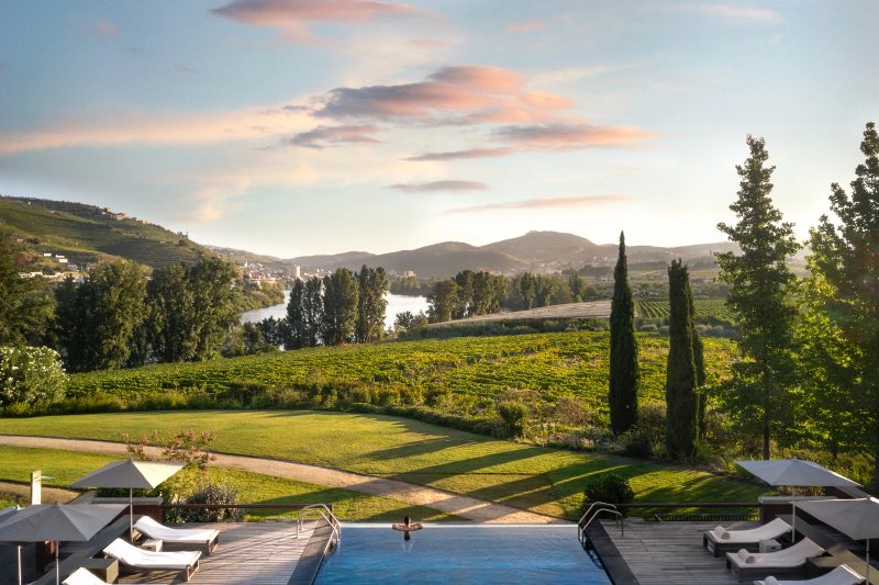 Six Senses Douro Valley outdoor pool overlooking the Douro river · golden-hour cocktail anchor
