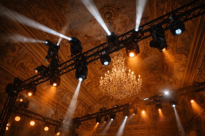 Lighting truss raised beneath a chandelier during a BTQ dinner production build