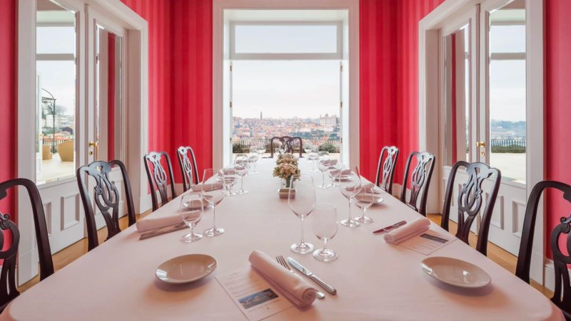 The Yeatman private dining room with long candle-lit table, pink curtains and Porto-skyline view, available for Two-Michelin-star Gastronomic Restaurant private hire under Chef Ricardo Costa and used by BTQ Events for wine-pairing corporate gala dinners